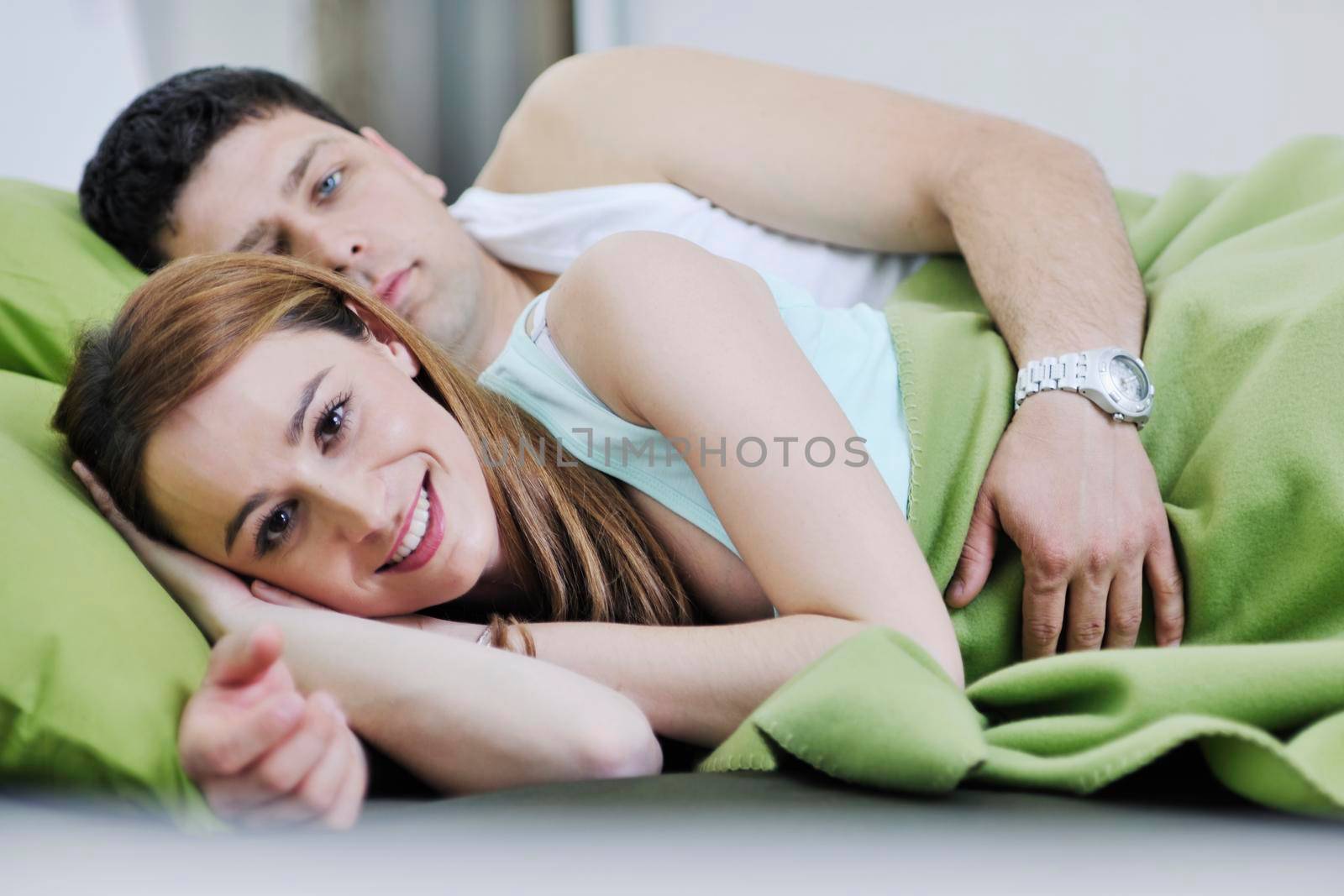 happy young couple in bed at morning