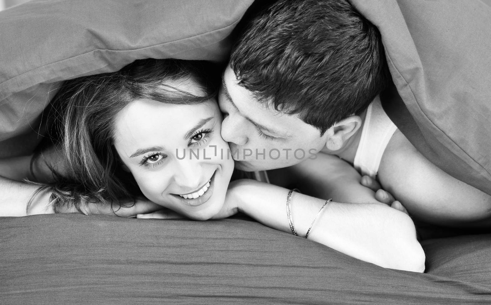 happy young couple in bed at morning