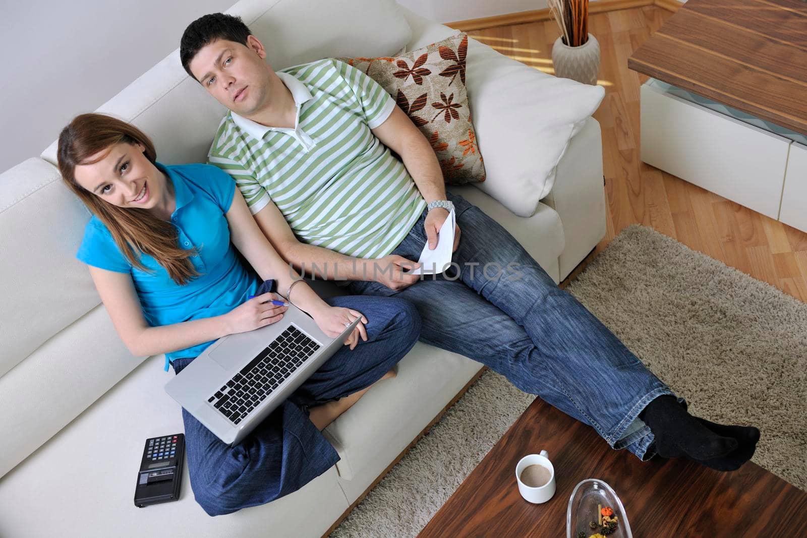 young couple at home with  modern livingroom indoor working on laptop on house finance and planing