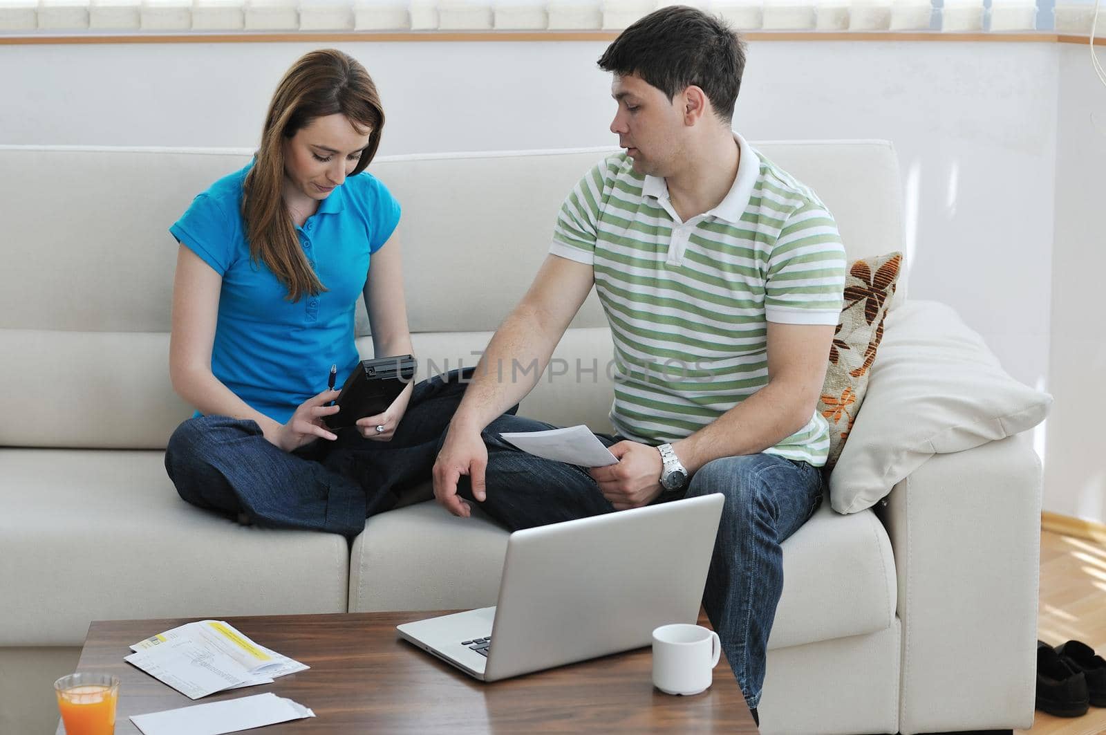 young couple at home with  modern livingroom indoor working on laptop on house finance and planing