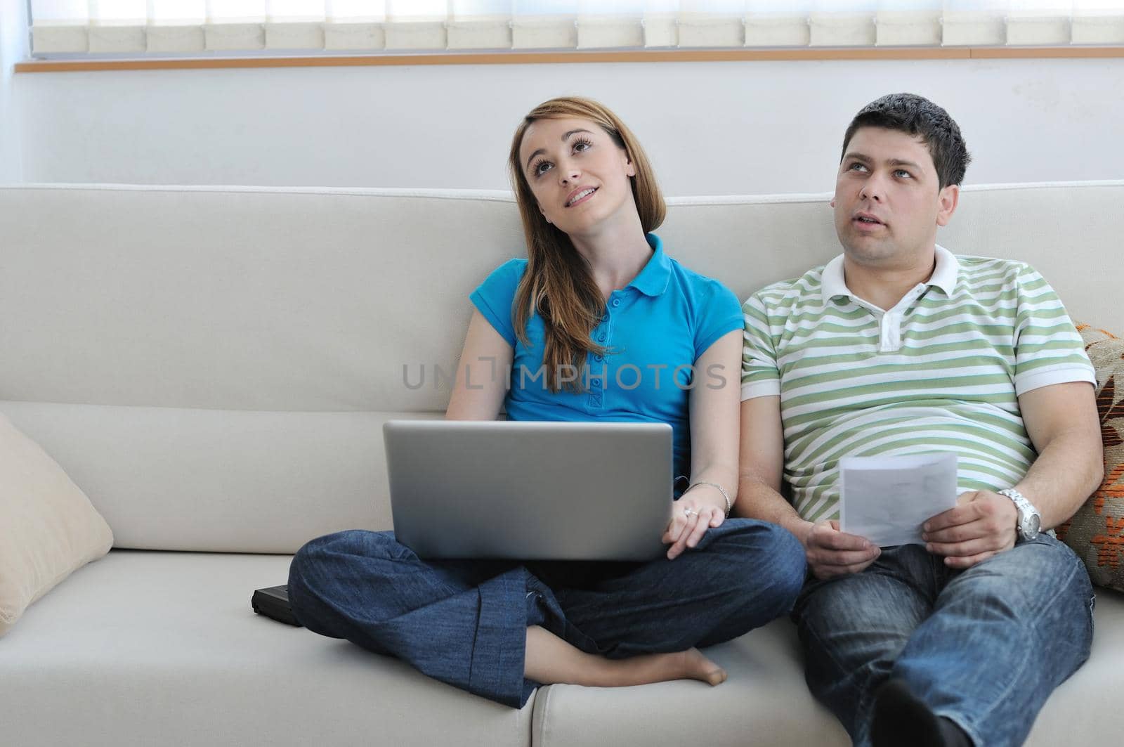 young couple at home with  modern livingroom indoor working on laptop on house finance and planing