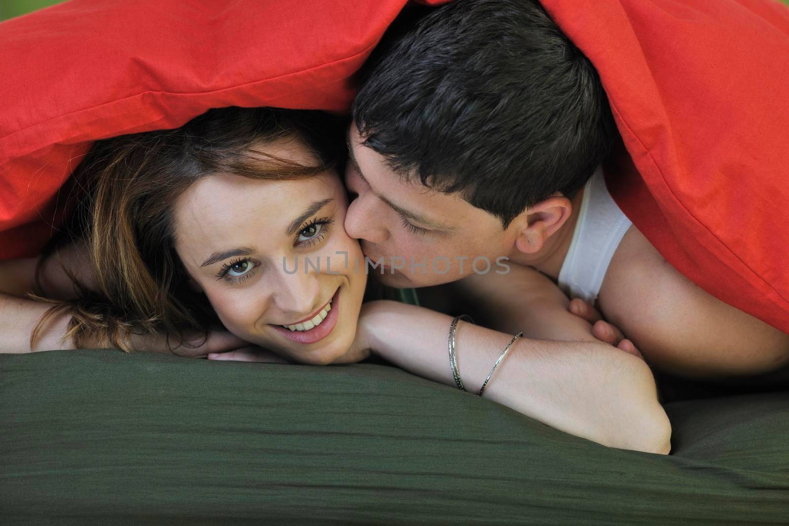 happy young couple in bed at morning