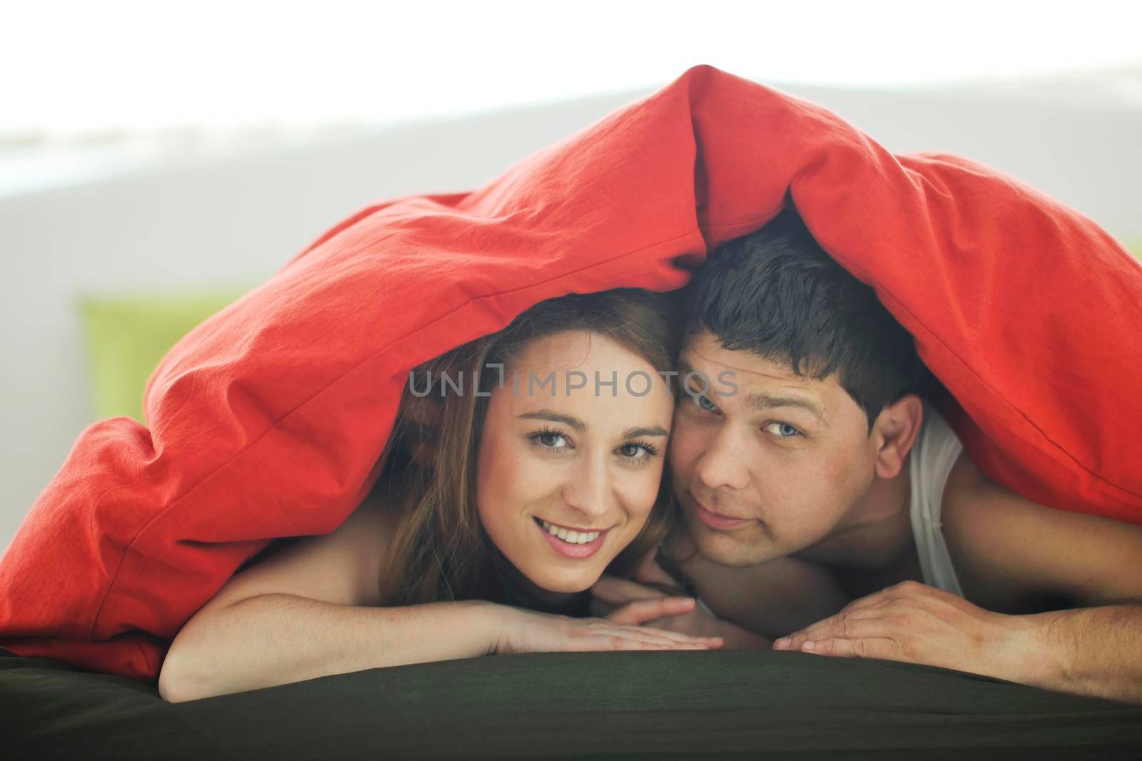 happy young couple in bed at morning