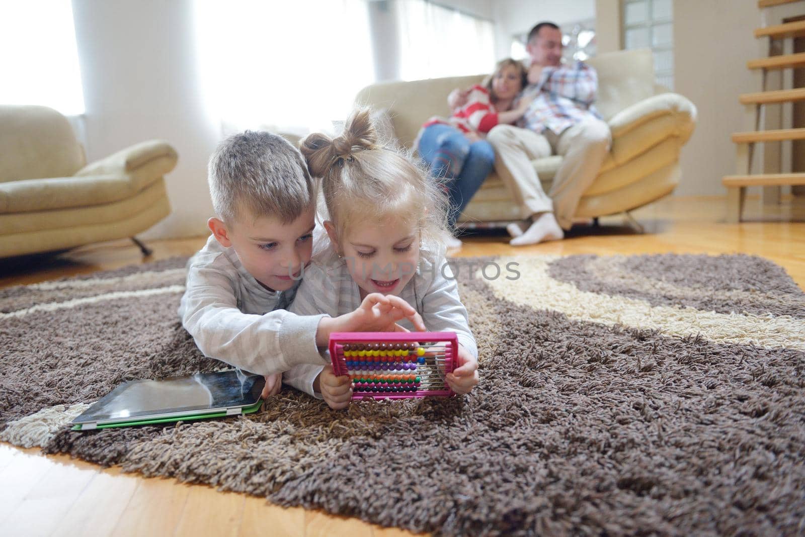 hapy young family have fun  with their children at modern living room home indoors