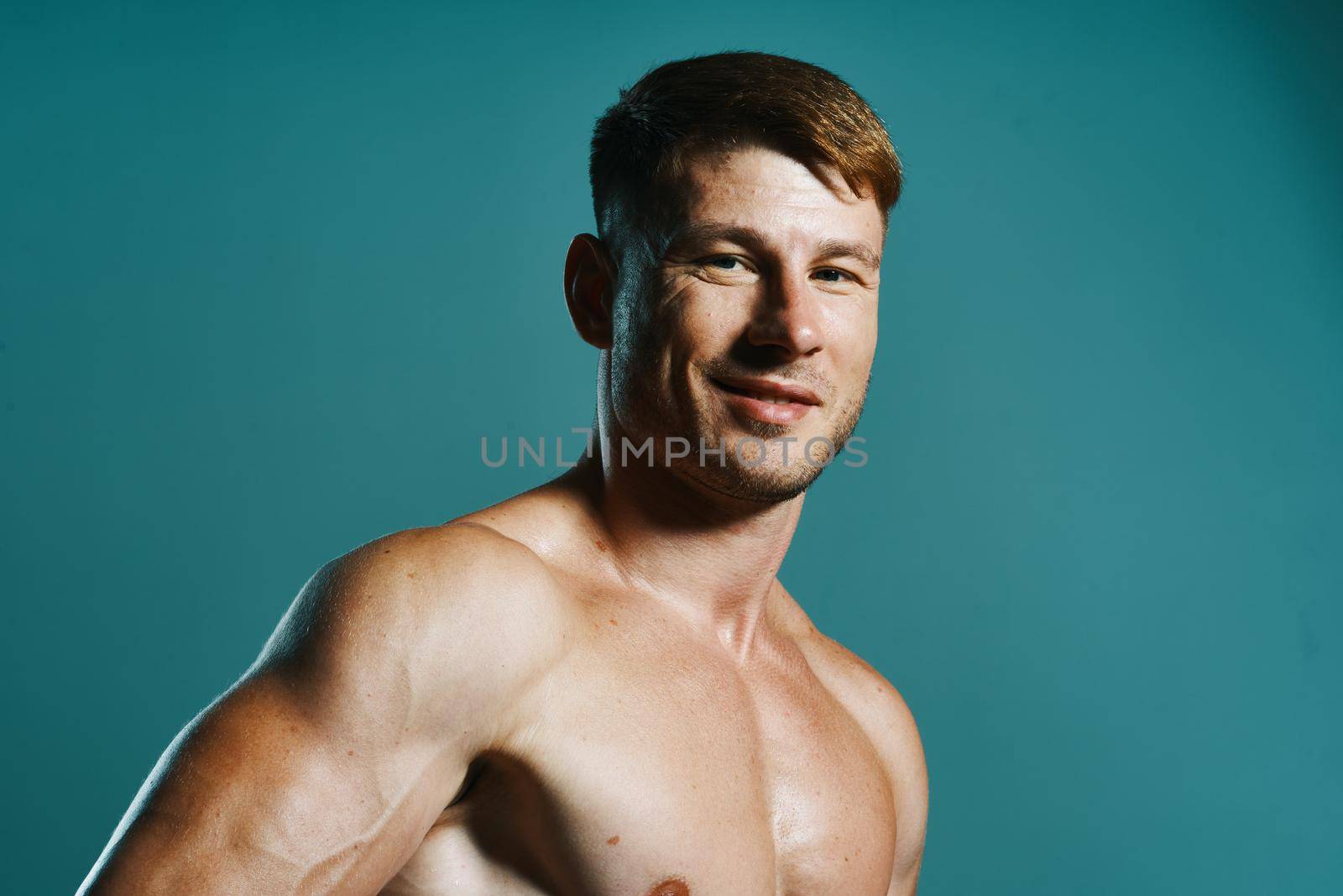 athletic man with pumped up muscular body workout green background. High quality photo