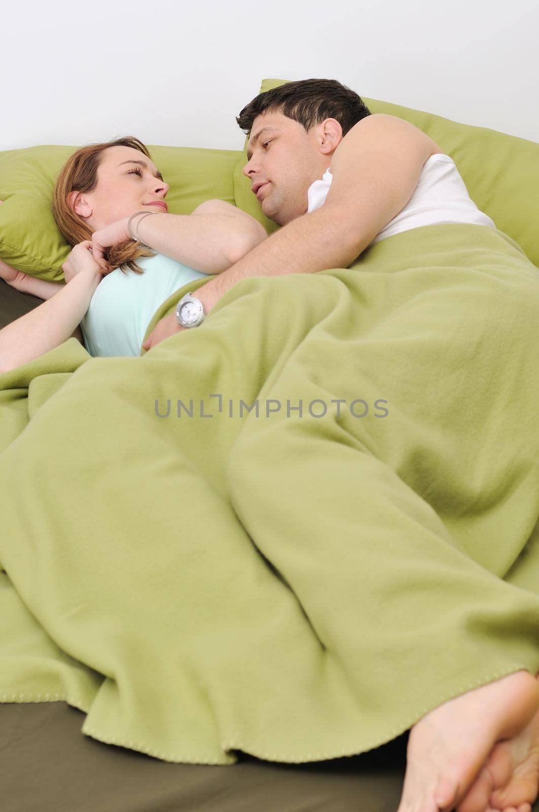 happy young couple in bed at morning