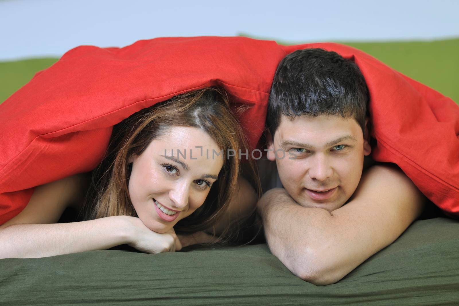 happy young couple in bed at morning