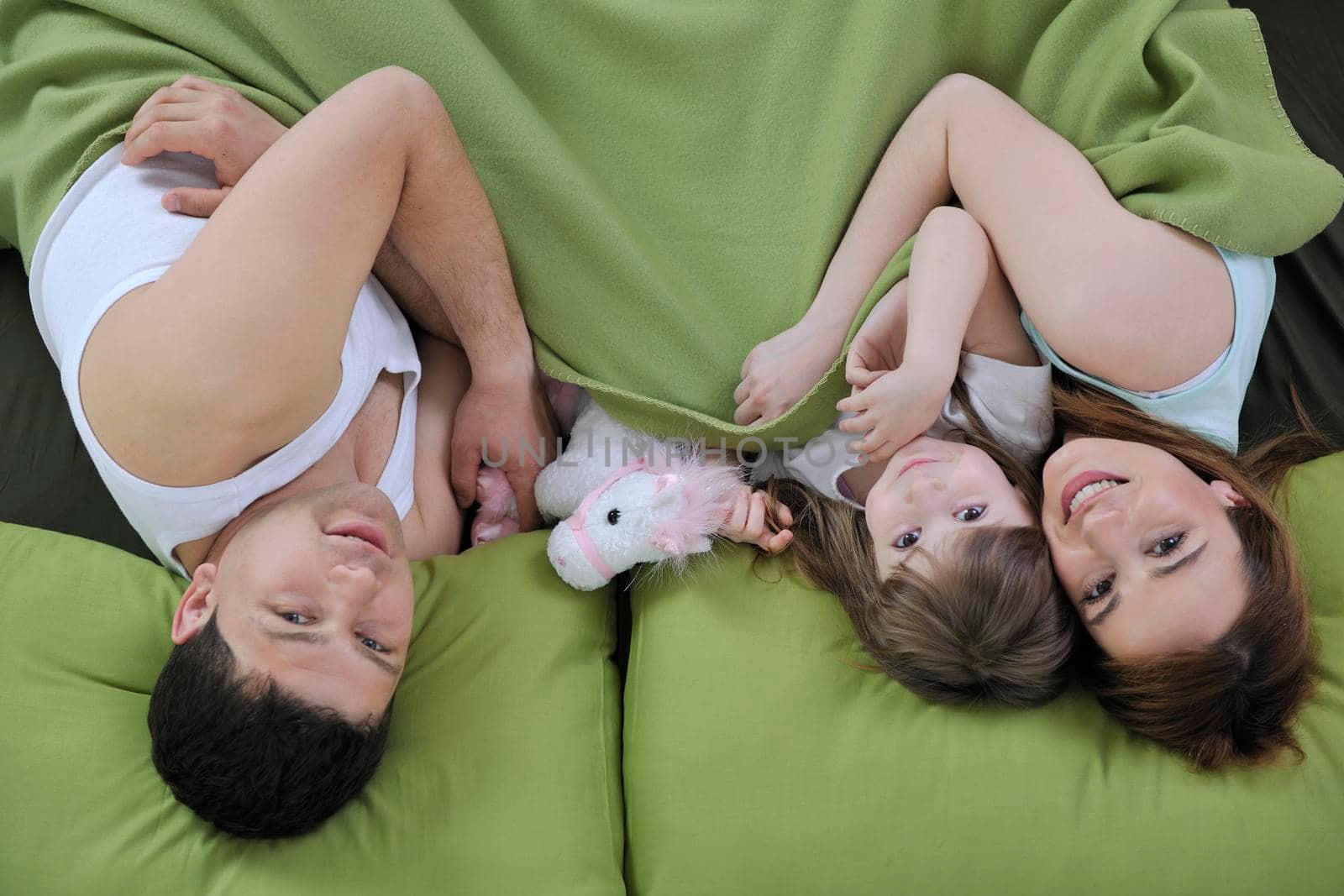 happy young family eat breakfast in bed at morning