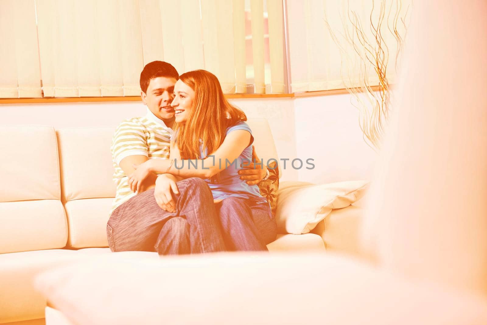 happy young couple relax at home in modern and bright living room 