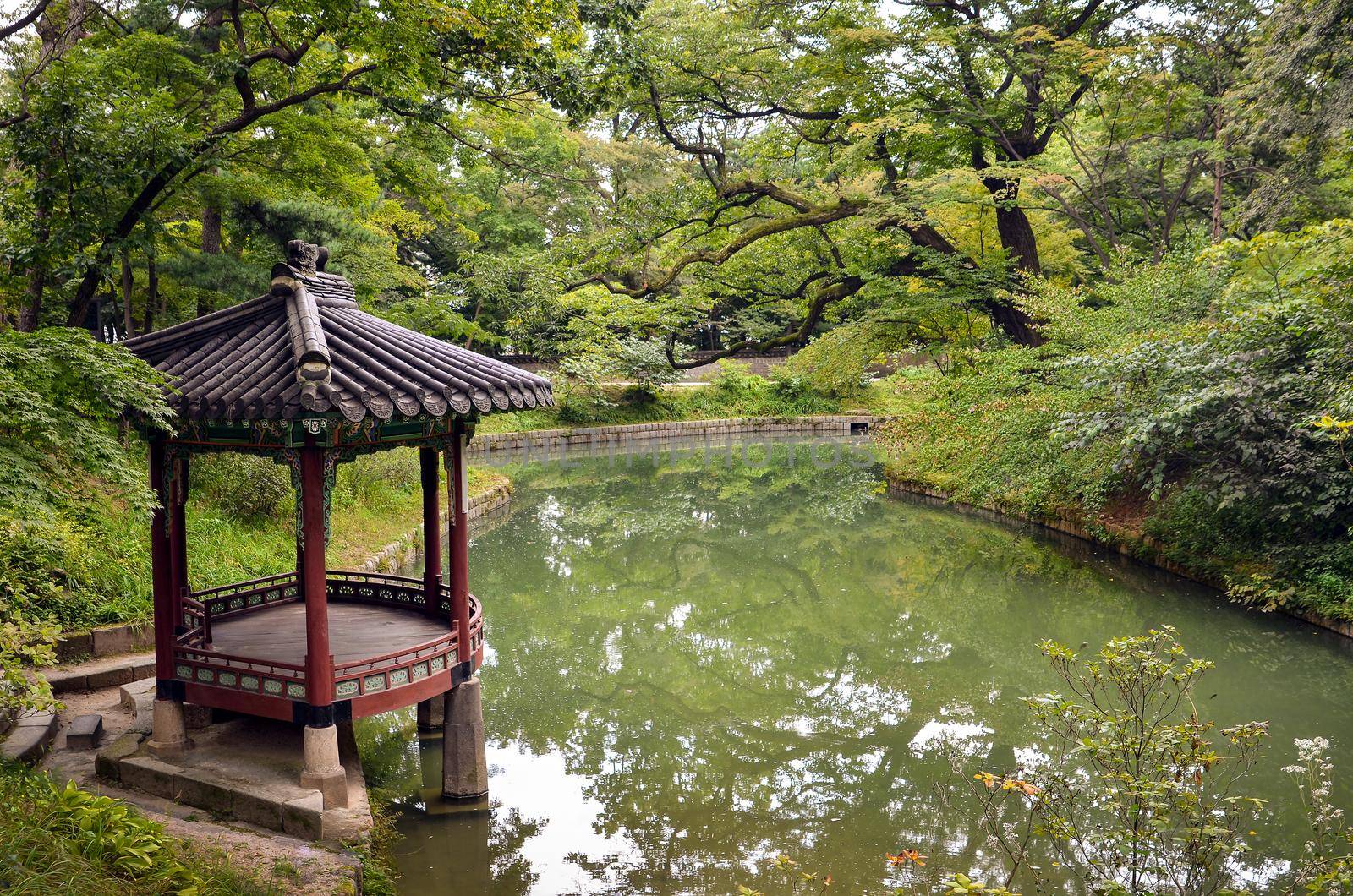 A Beautiful Korean Traditional Garden with gazebo and small lake.