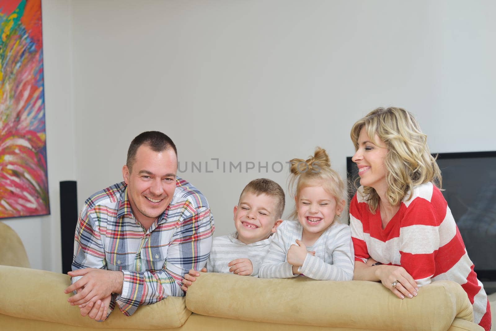 hapy young family have fun  with their children at modern living room home indoors