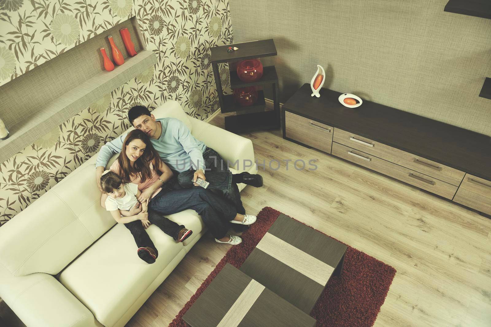 happy youg family relaxing in modern livingroom at home
