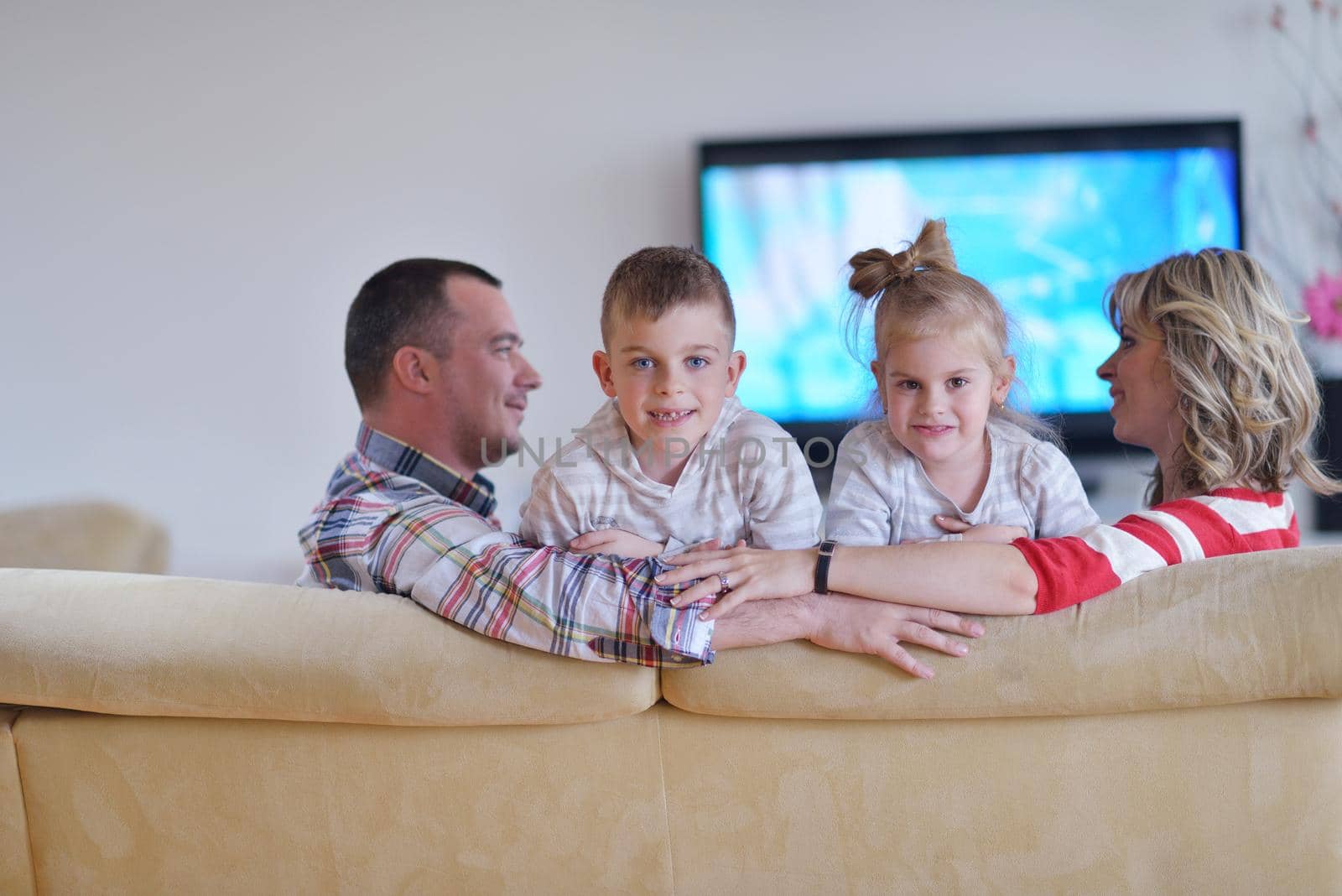 hapy young family have fun  with their children at modern living room home indoors