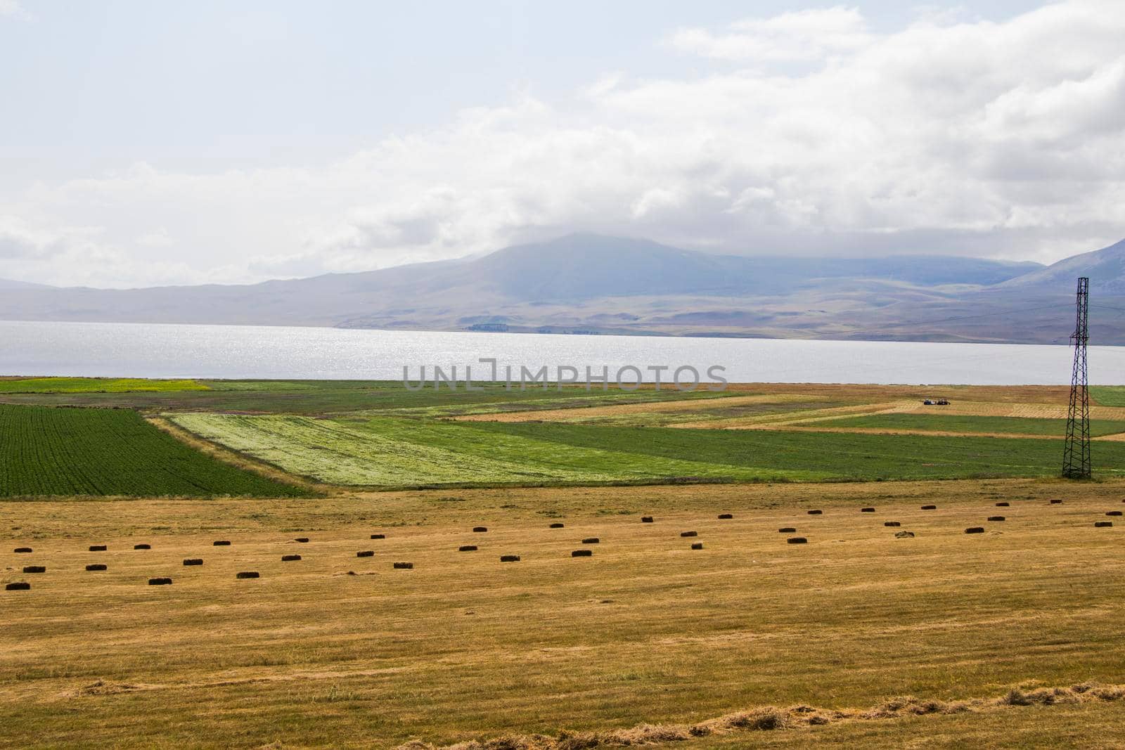 Haystacks and rolls, agriculture in Georgia, dry hay and mountain landscape with Faravani lake