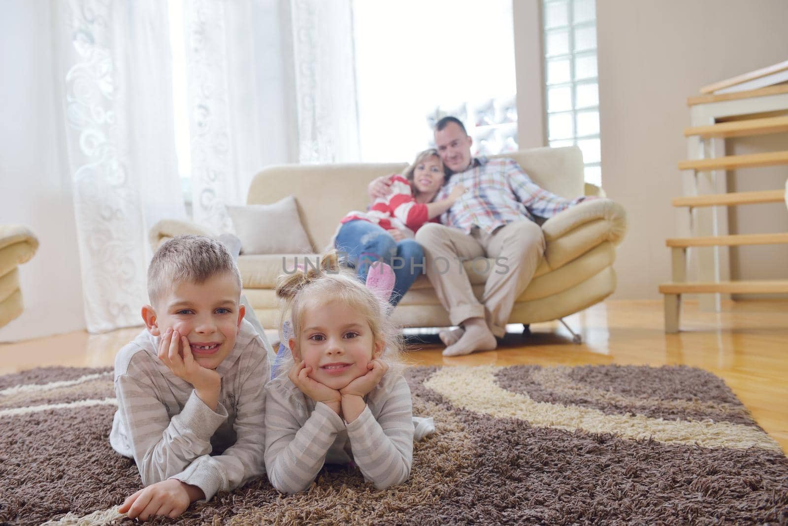 hapy young family have fun  with their children at modern living room home indoors