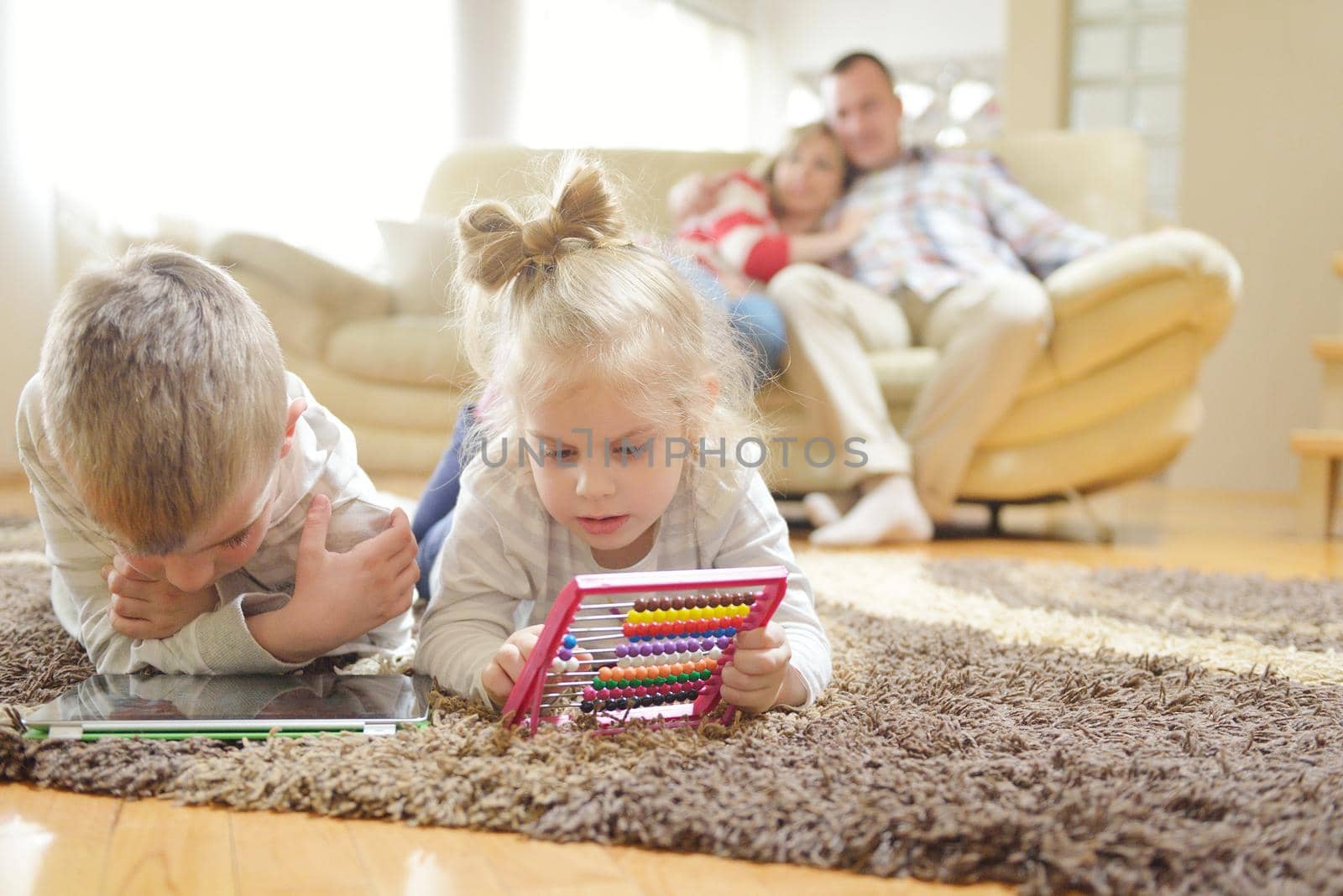 hapy young family have fun  with their children at modern living room home indoors