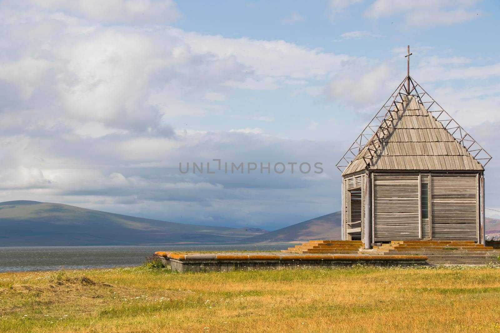 Old abandoned church and lake landscape in Paravani lake, Georgia