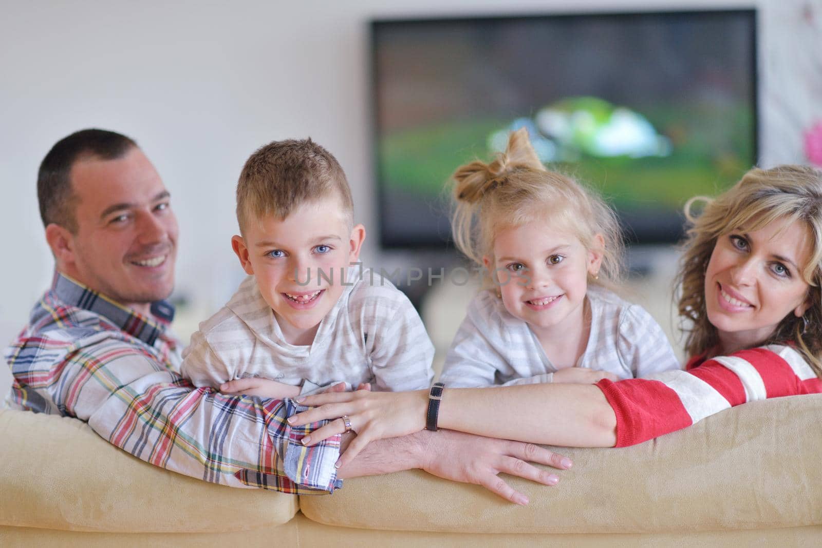 hapy young family have fun  with their children at modern living room home indoors