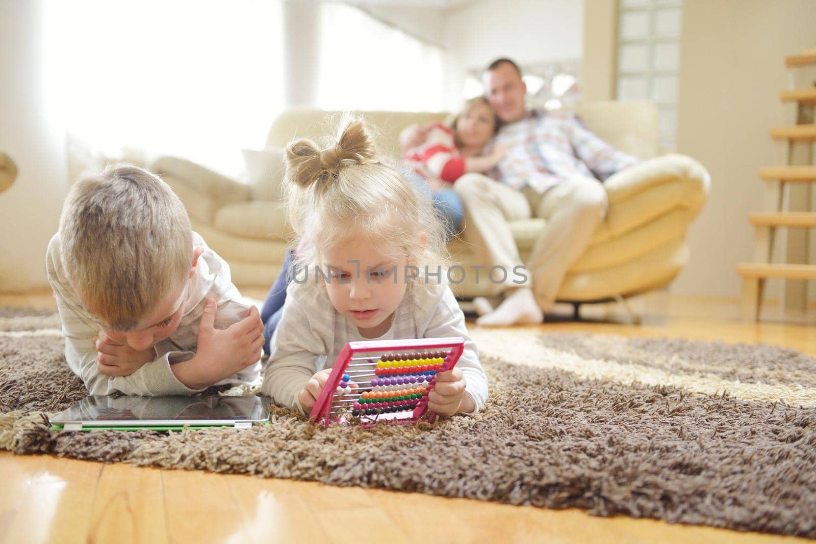 hapy young family have fun  with their children at modern living room home indoors