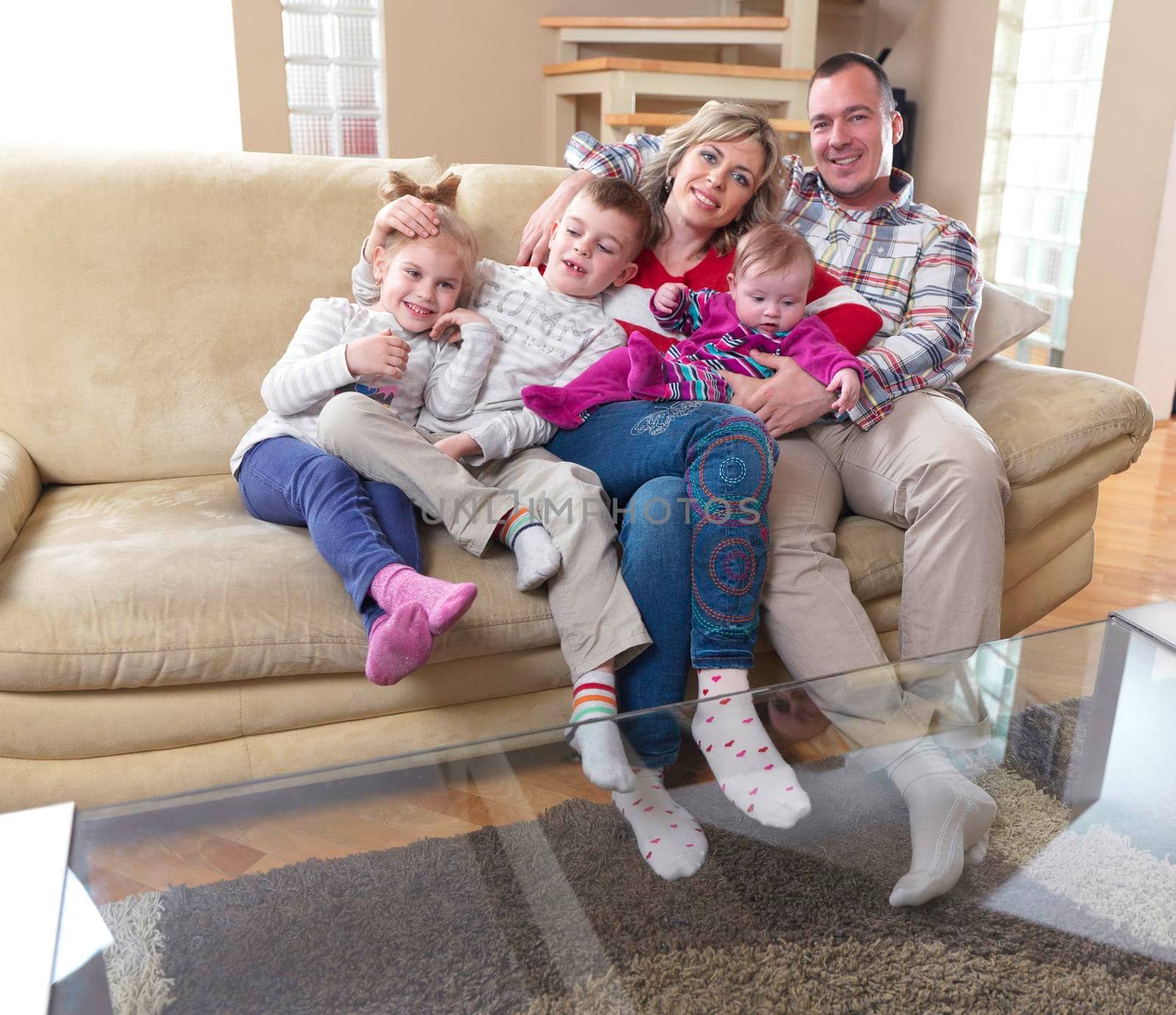 hapy young family have fun  with their children at modern living room home indoors