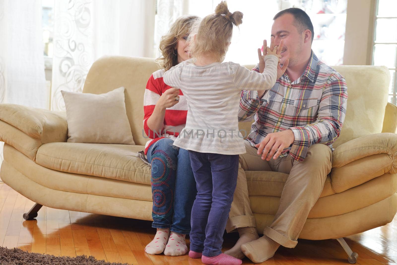 hapy young family have fun  with their children at modern living room home indoors