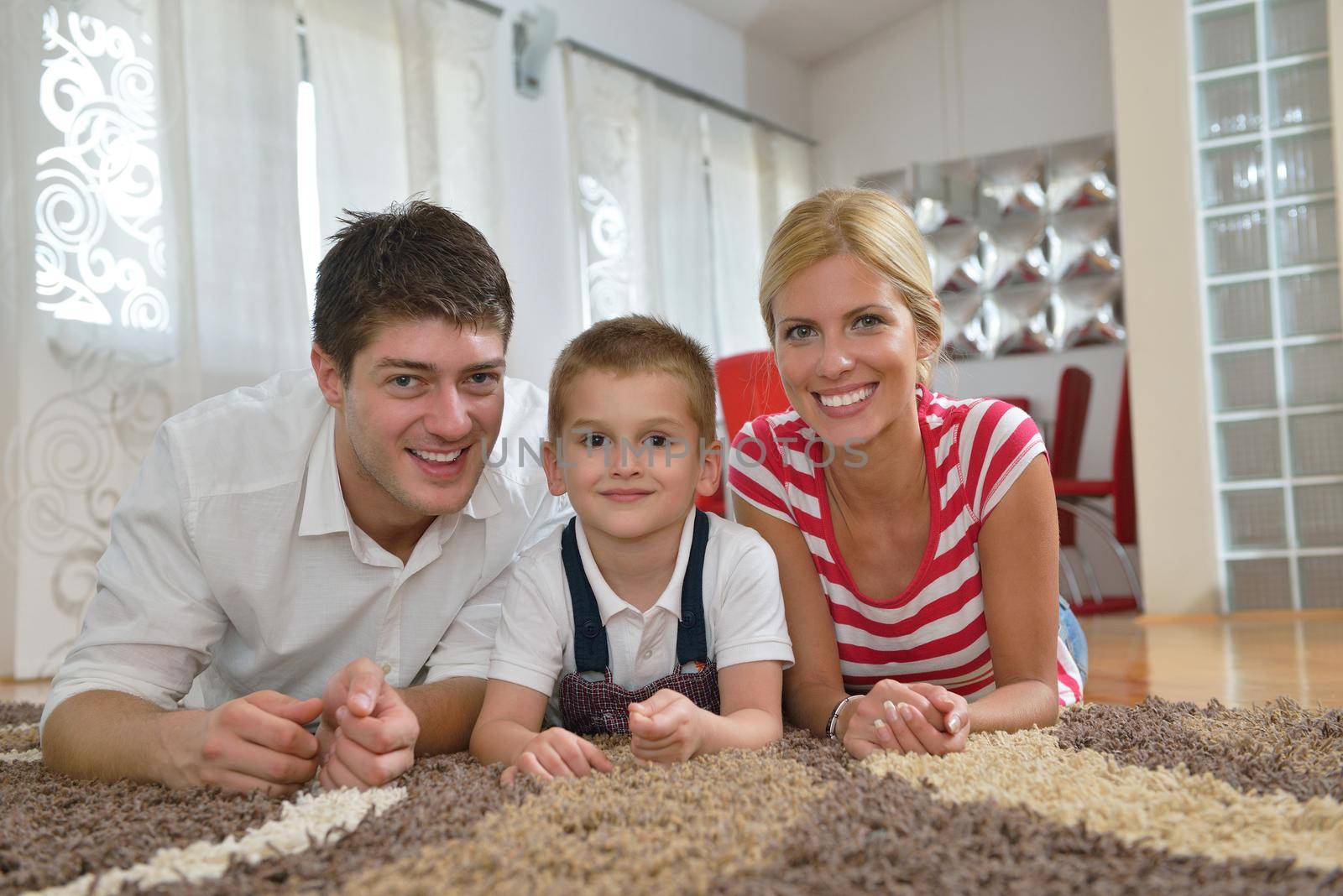 happy young family with kids in bright modern living room have fun and looking big flat lcd tv