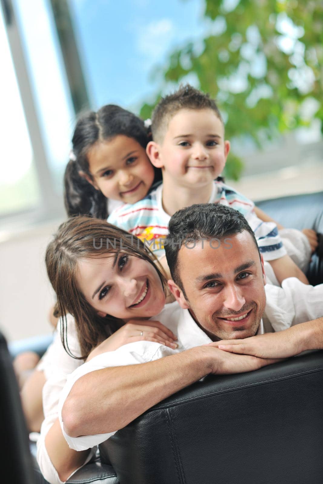 happy young family relax and have fun at modern home indooor