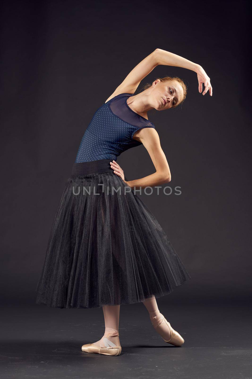 women ballerina in a black dress dance fashion exercise isolated background. High quality photo