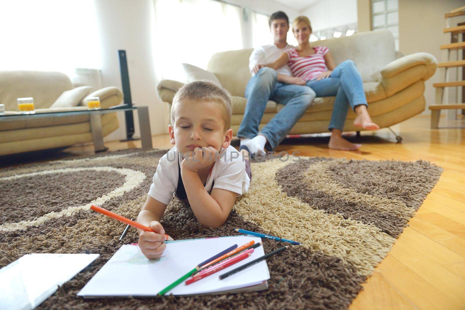 happy young family with kids in bright modern living room have fun and looking big flat lcd tv