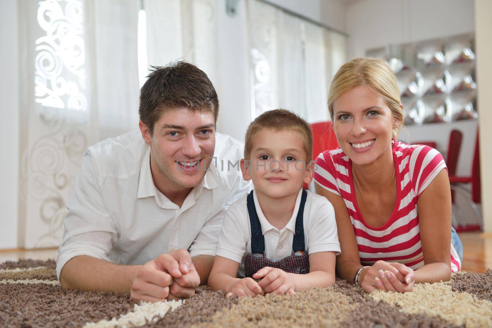 happy young family with kids in bright modern living room have fun and looking big flat lcd tv