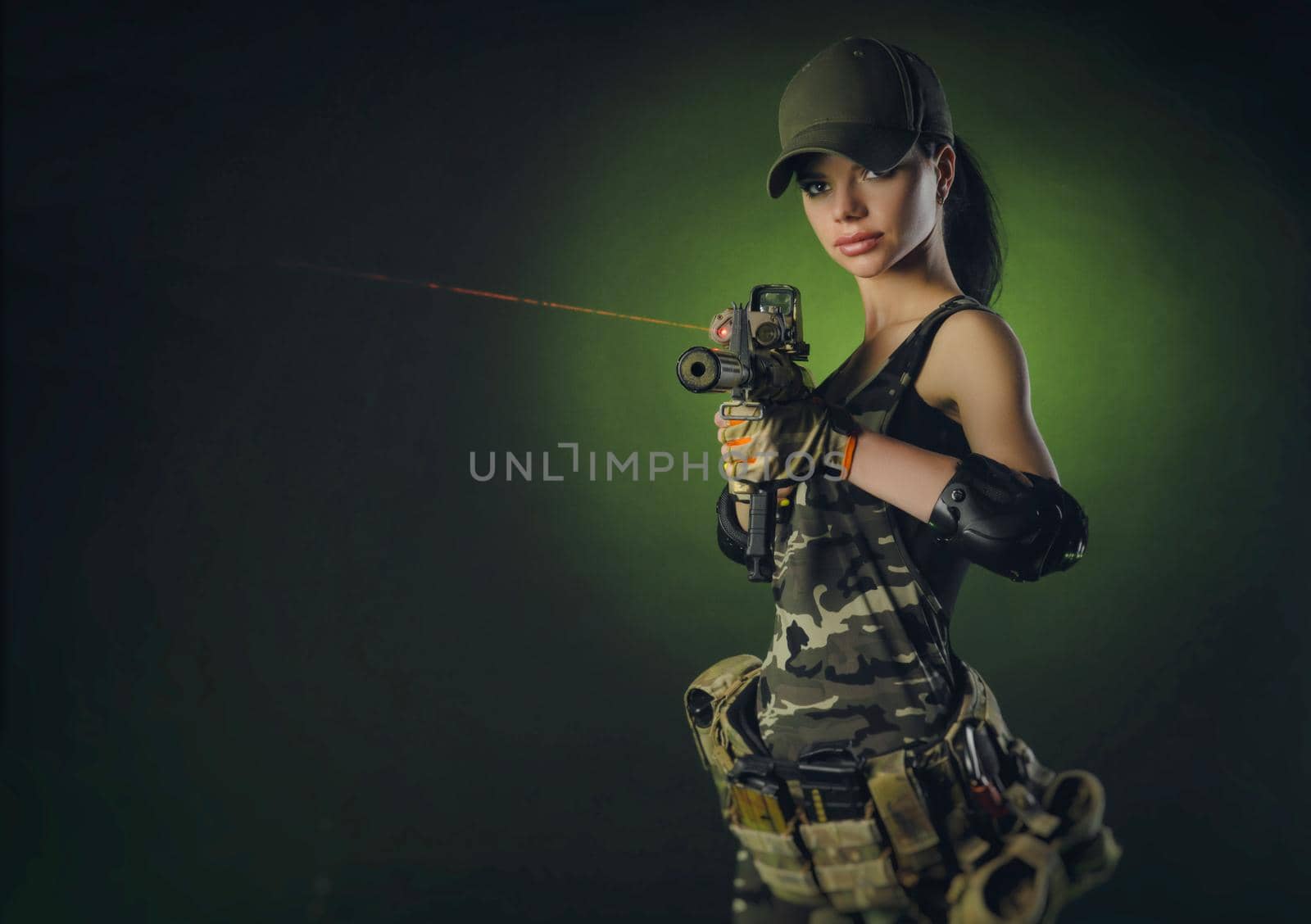 a soldier girl poses with an automatic rifle by Rotozey