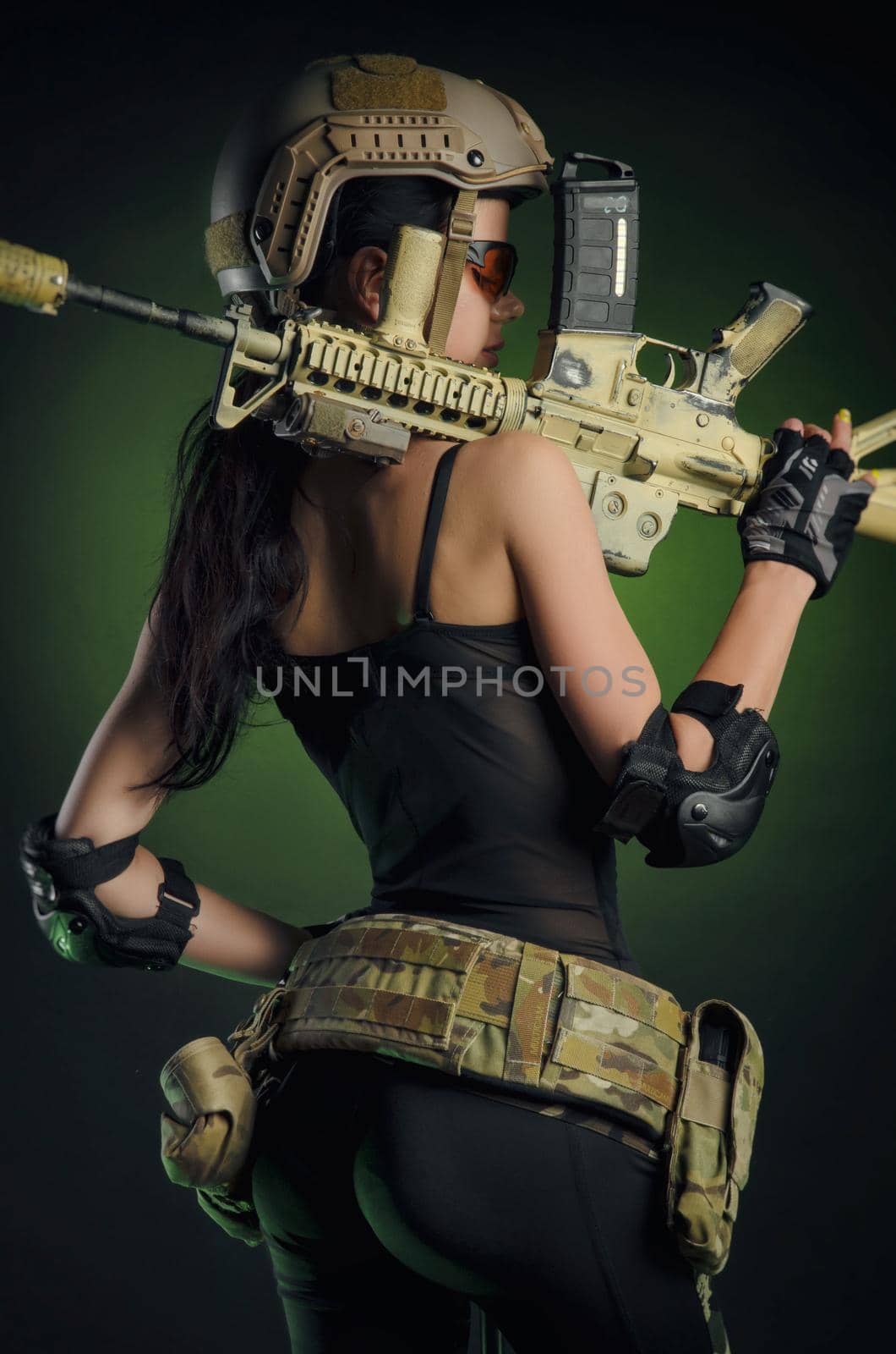 a soldier girl poses with an automatic rifle by Rotozey