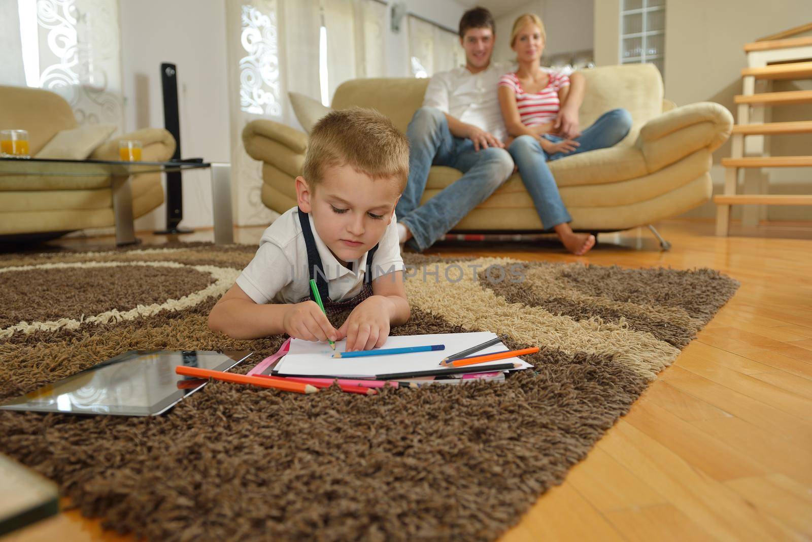 happy young family with kids in bright modern living room have fun and looking big flat lcd tv