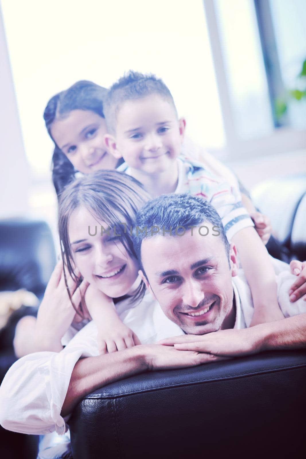 happy young family relax and have fun at modern home indooor