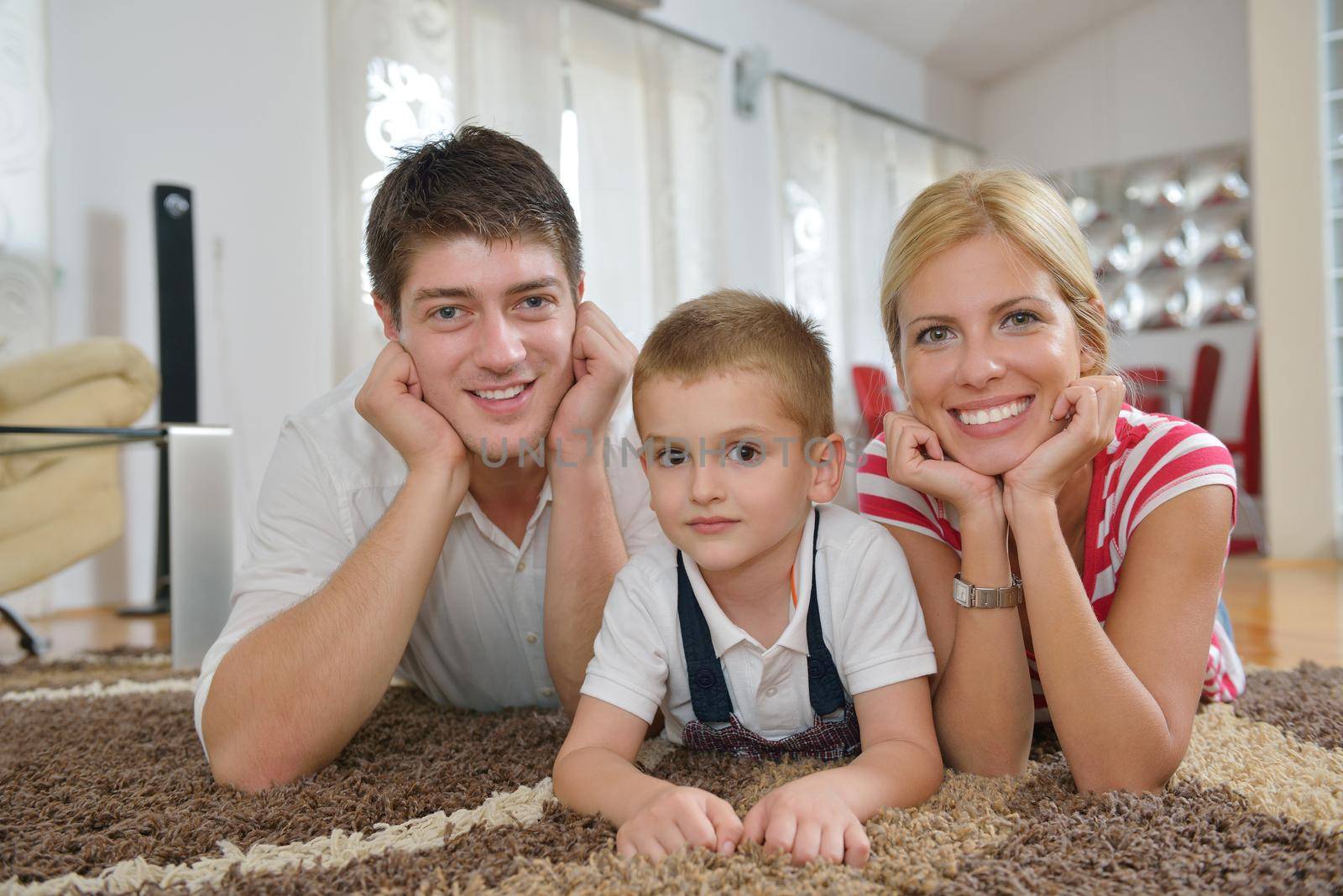 happy young family with kids in bright modern living room have fun and looking big flat lcd tv