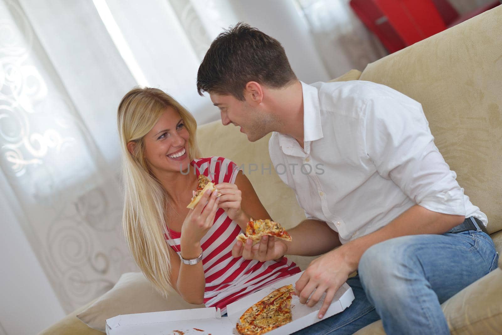 couple at home eating  pizza by dotshock