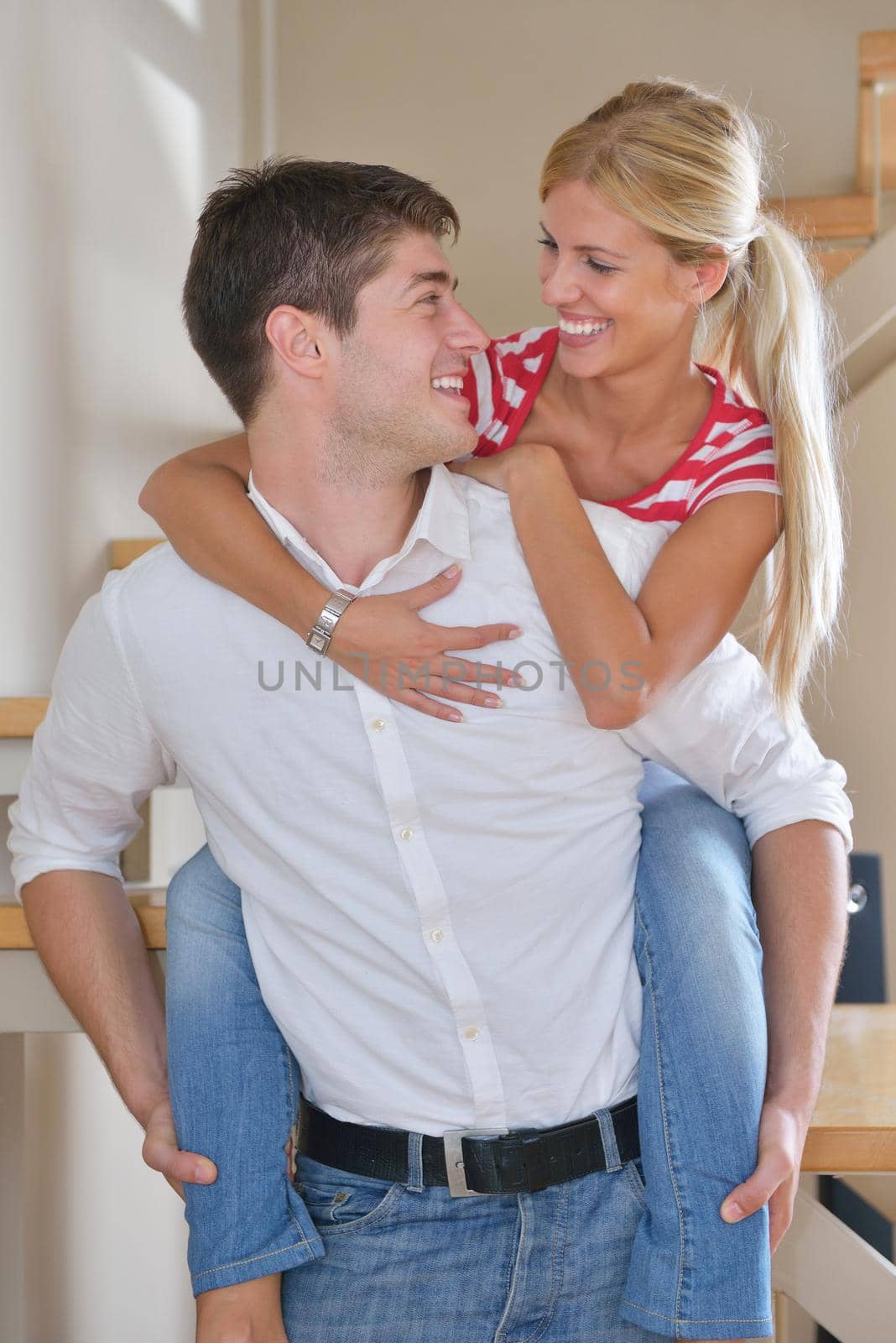 Relaxed young  couple watching tv at home in bright living room