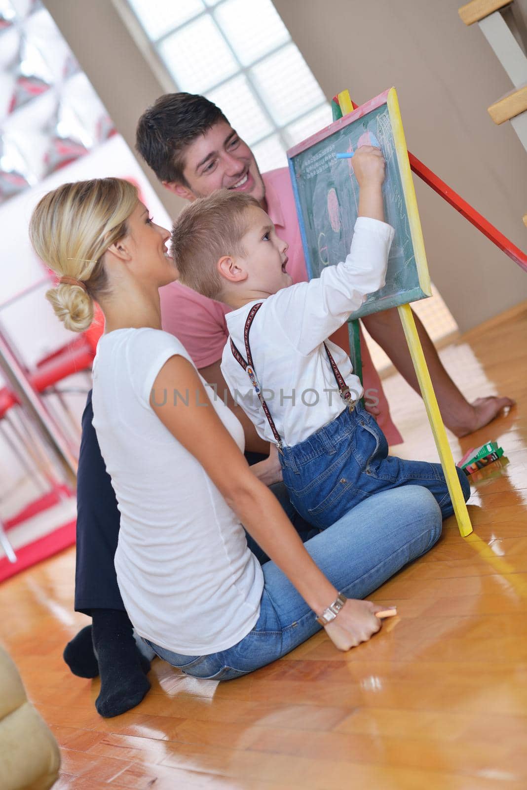 family drawing on school board at home by dotshock