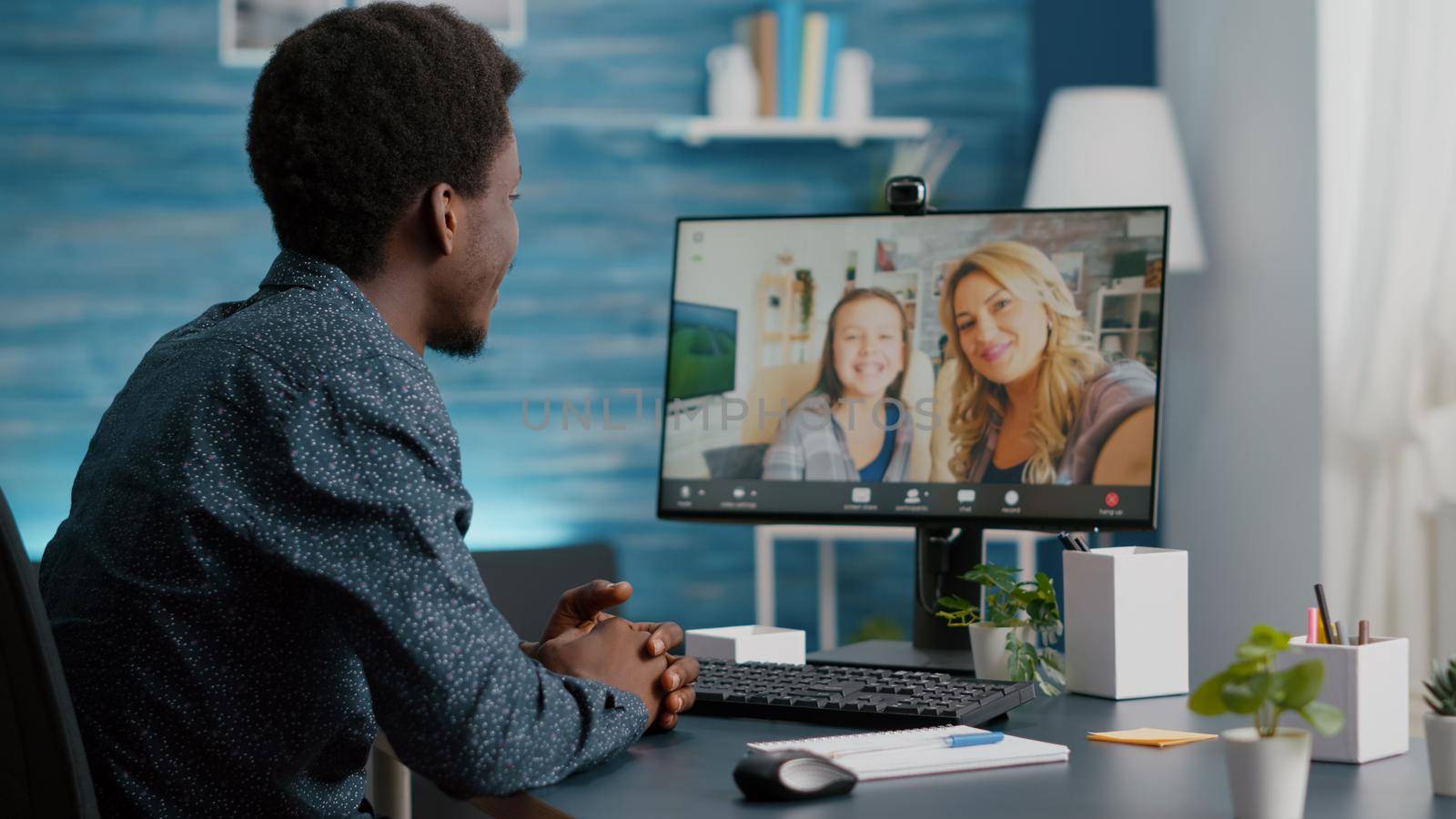 Selective focus on african american man talking with friends and family using online video call communication and webcam. Black man video conference from home office, remote intenet chat conversation