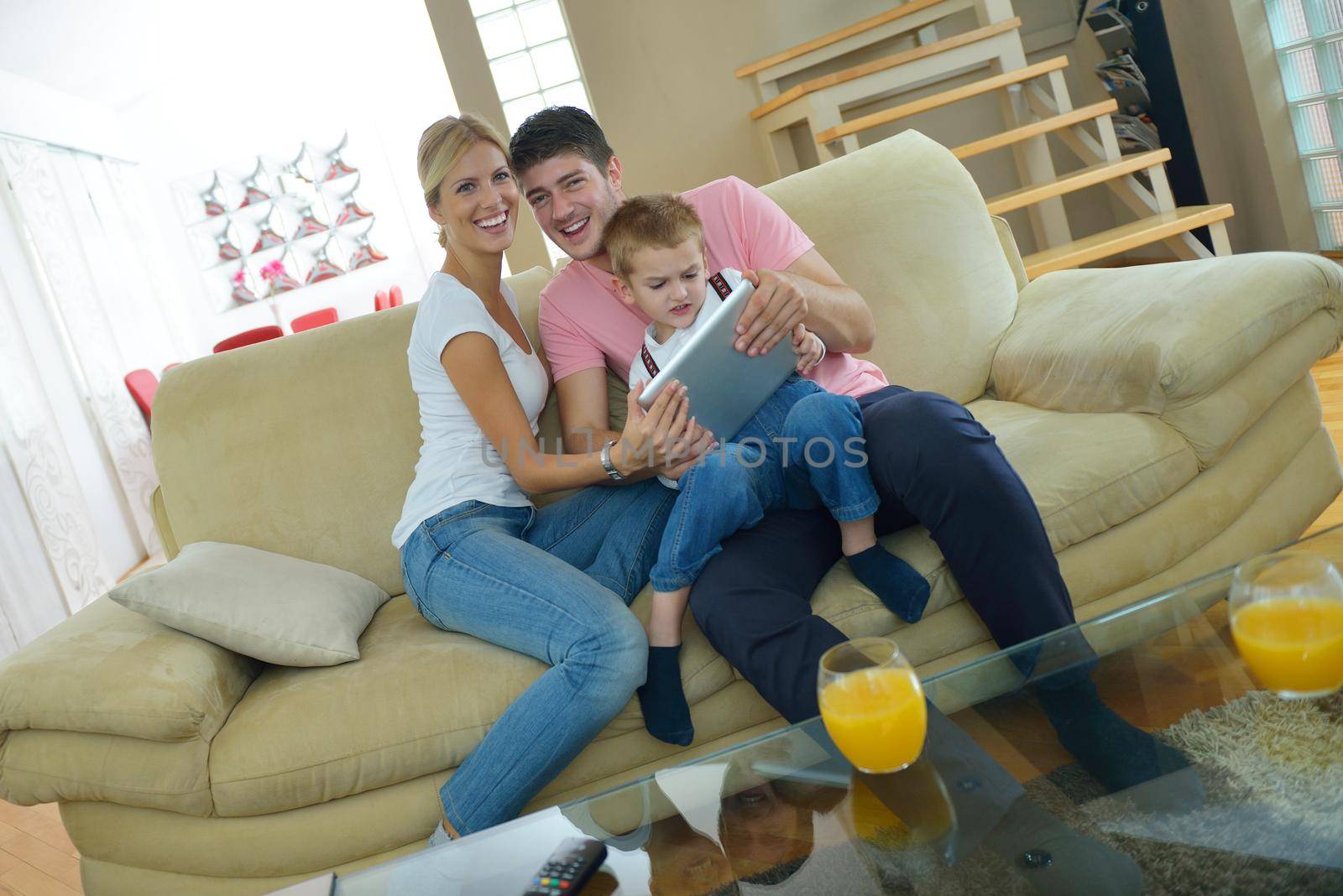 family at home using tablet computer by dotshock