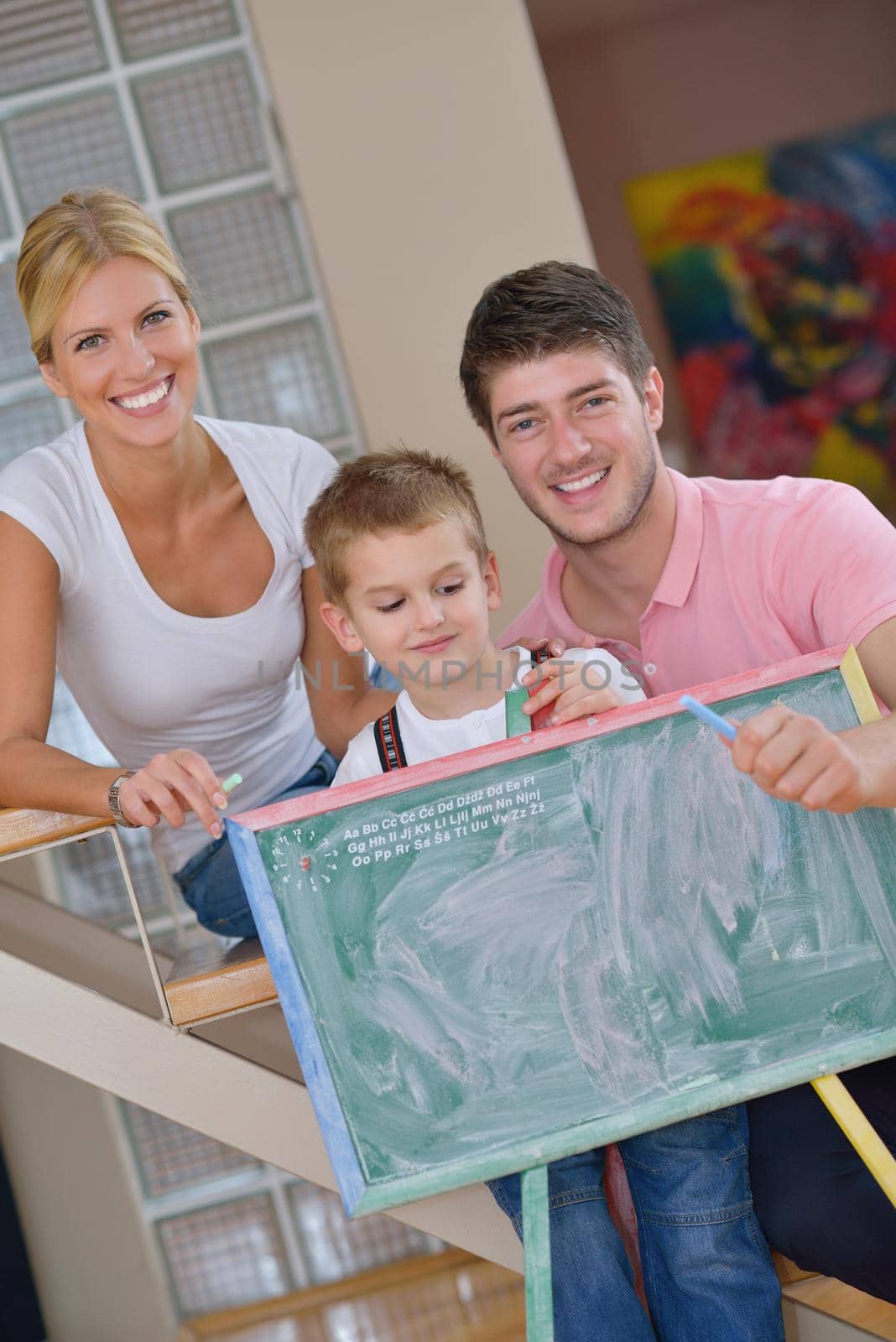 family drawing on school board at home by dotshock