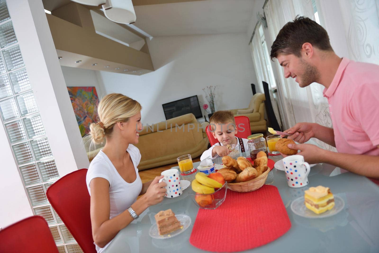 family have healthy breakfast at home by dotshock