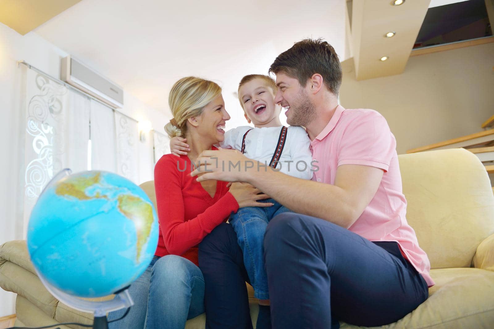 happy young family have fun with globe