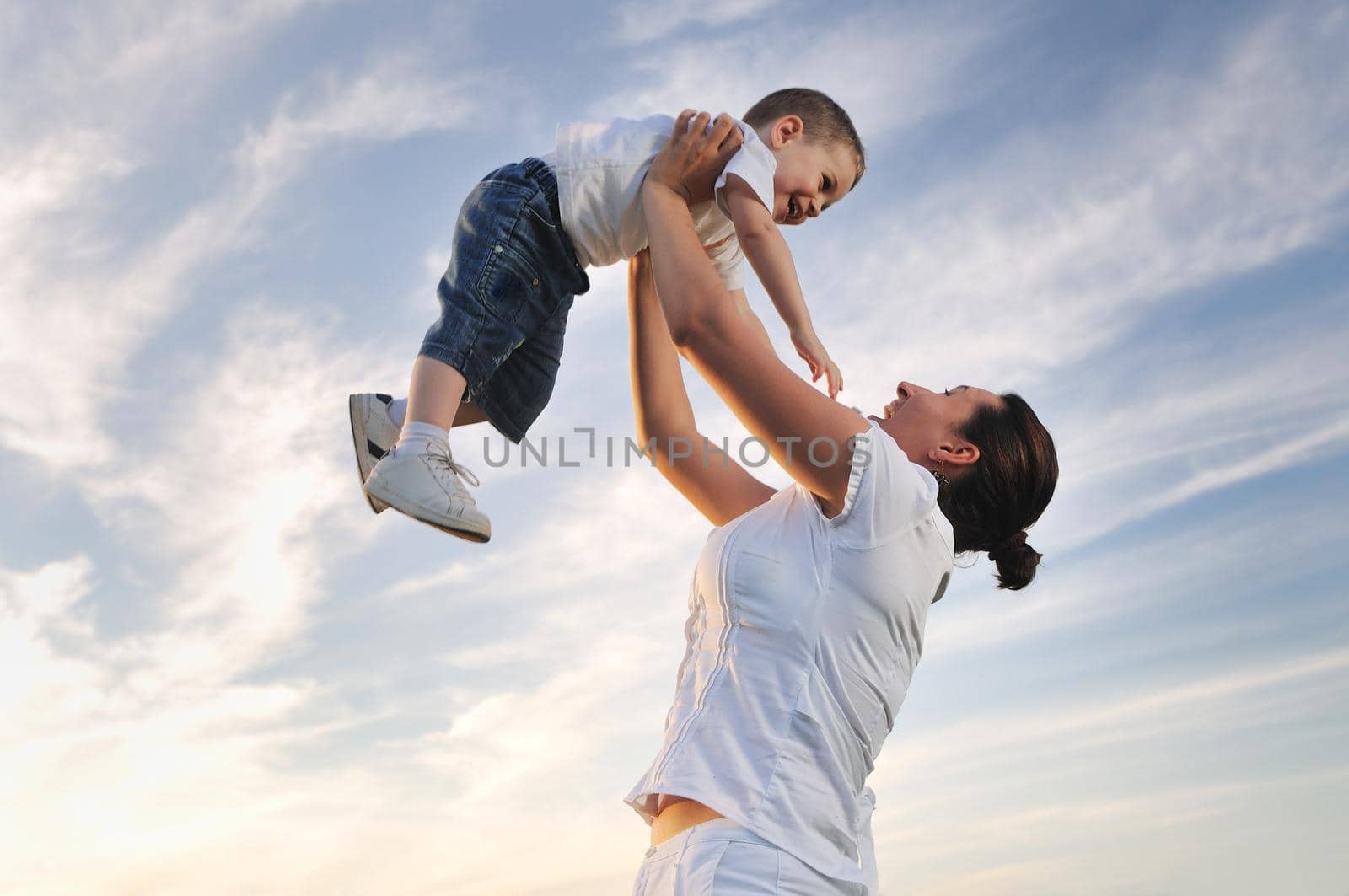 happy young woman mother play and outdoor with beautiful child