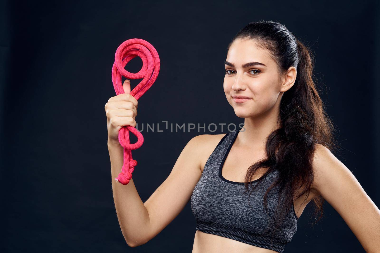 sportive woman workout equipment gymnasium lifestyle black background. High quality photo