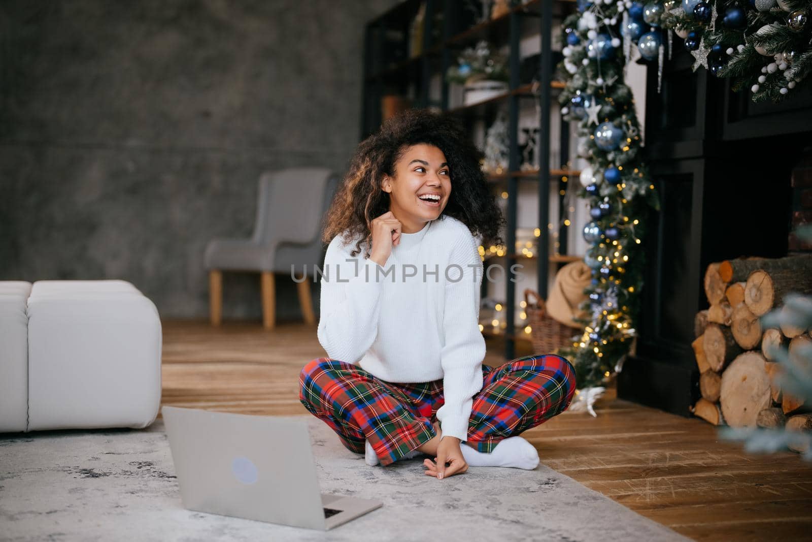 Beautiful young african american woman on the floor happy face smiling and looking at the camera. Positive person.