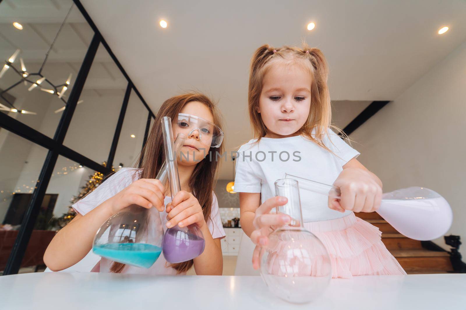 Girl making chemical experiments at home, close view.