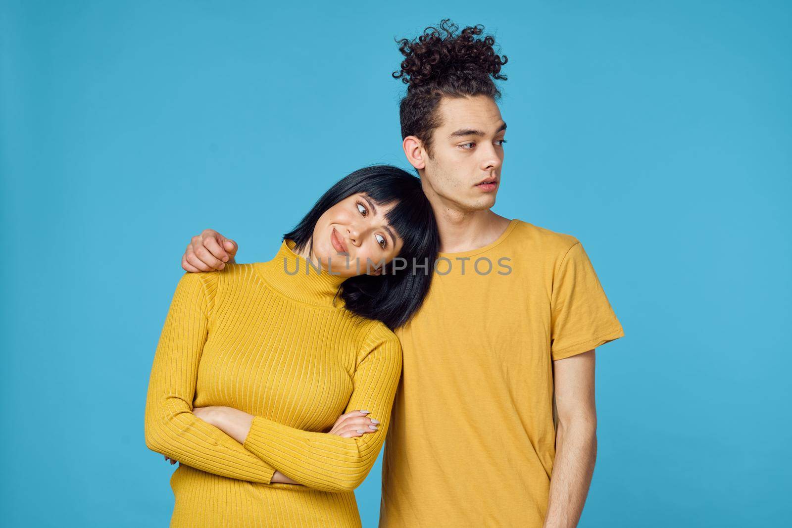 kinky guy and girl together friendship fun blue background. High quality photo