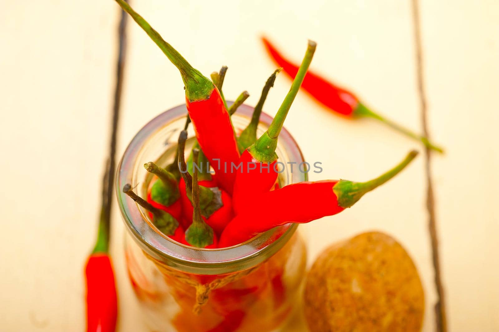 red chili peppers on a glass jar by keko64