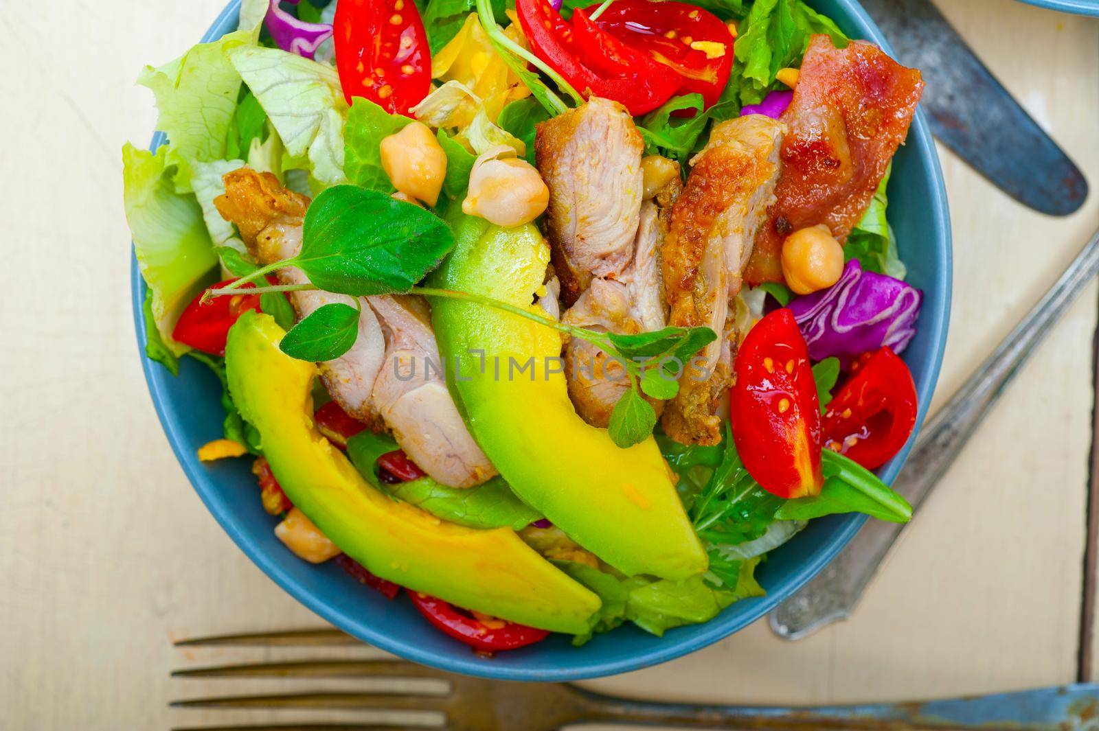 fresh and healthy Chicken Avocado salad over rustic wood table